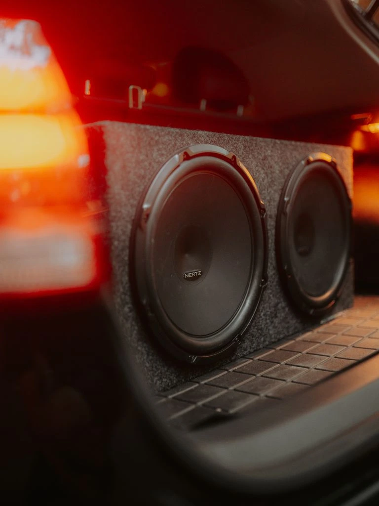 Masterfit installer fitting a subwoofer enclosure into a ute boot